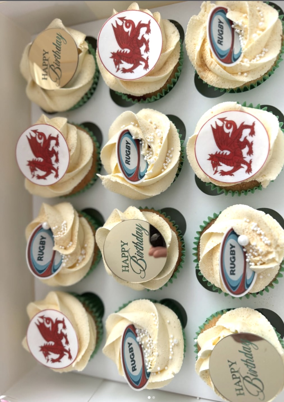 Cream cupcakes with rugby and Welsh dragon toppers